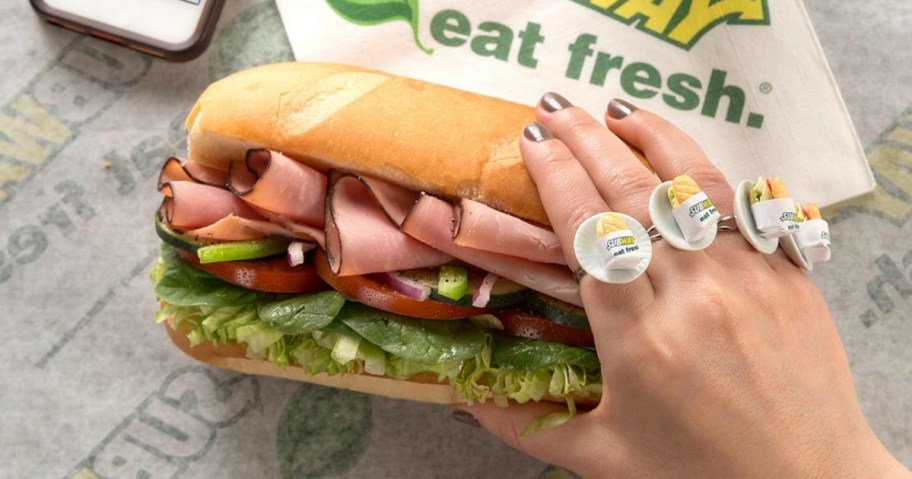 hand holding Subway sandwich