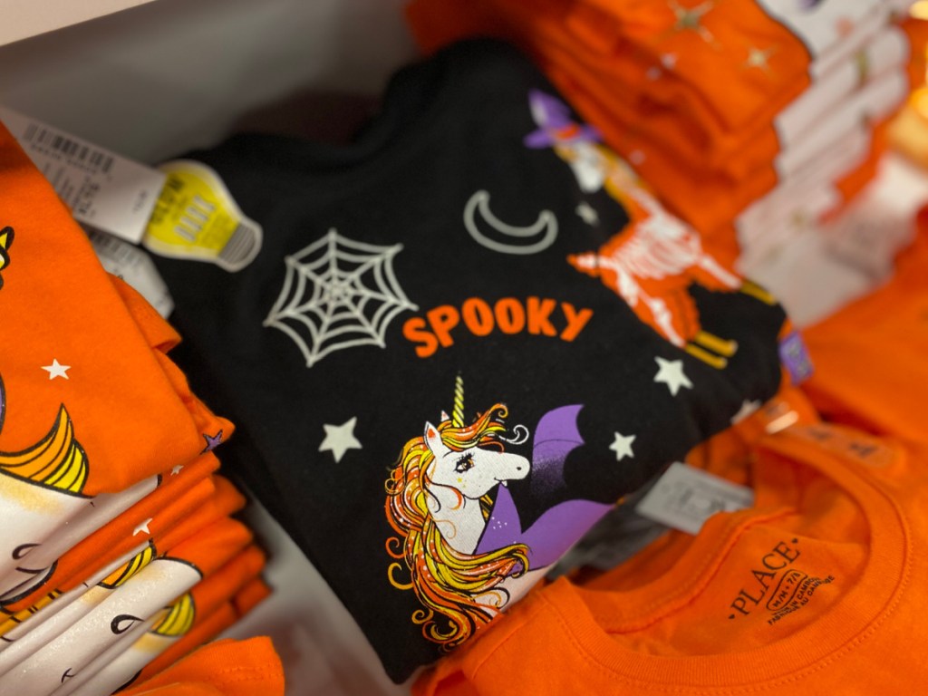 Store shelf with black spooky Halloween Tee