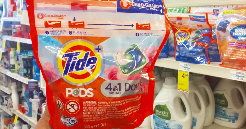 hand holding tide pods packet in store at cvs
