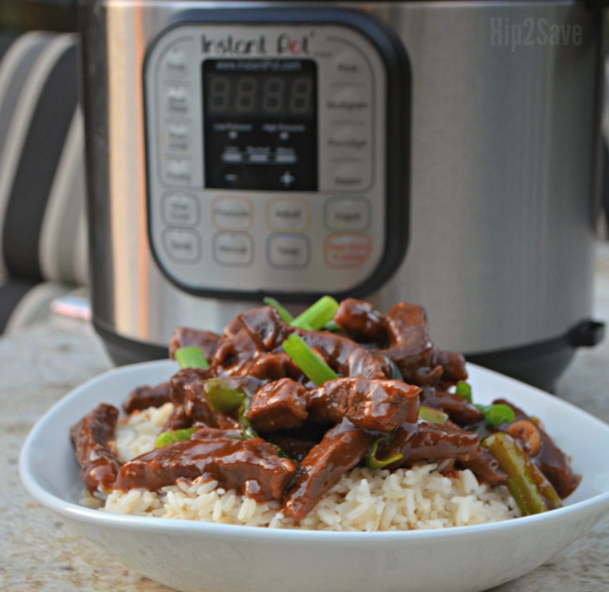 Mongolian beef served over rice in front of an instant pot