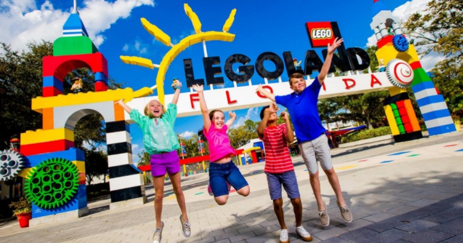 family jumping outside of LEGOLAND Florida sign 
