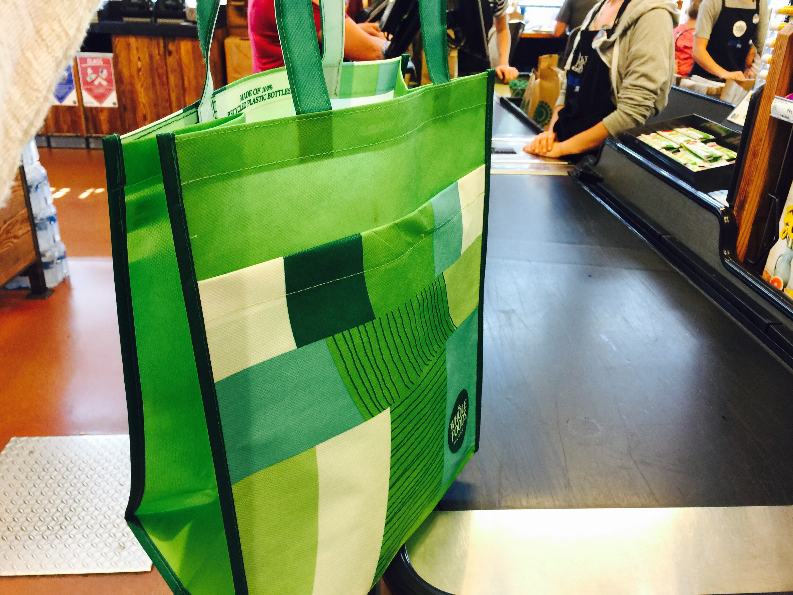 money-saving hacks at Whole Foods Market – reusable bag on a conveyor belt