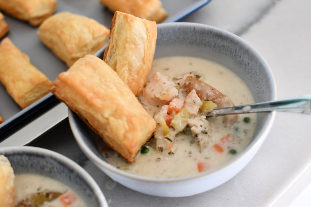 dishing up a bowl of chicken pot pie soup
