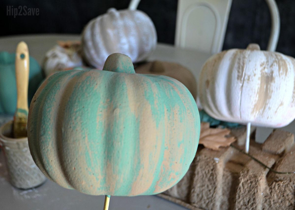 craft pumpkin covered in teal and tan paint