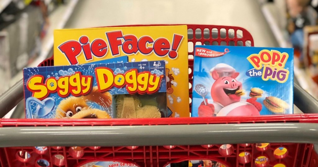 red target shopping basket filled with pie face, soggy doggy, and pop the pig kids board games