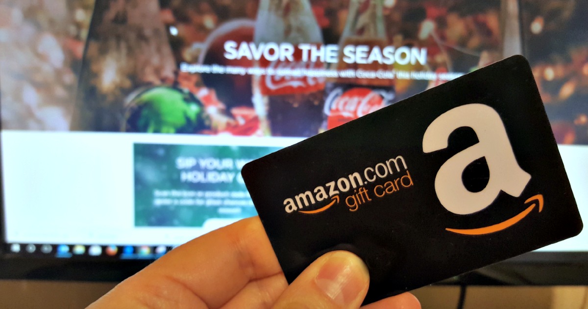 person holding an Amazon gift card in their hand