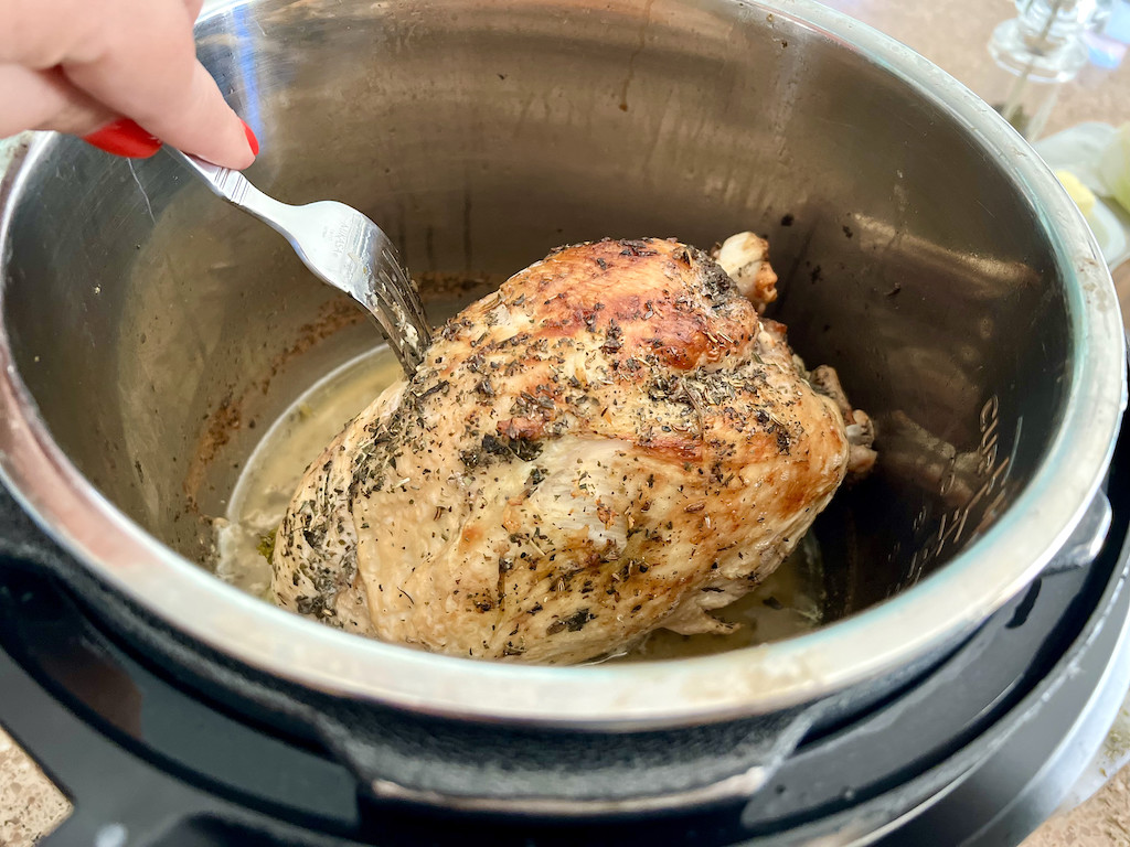 stabbing Instant Pot turkey breast with a fork