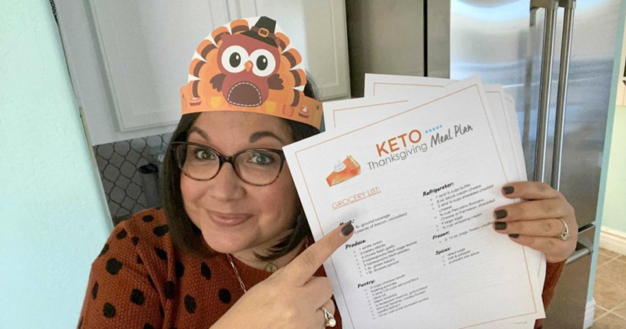 woman wearing thanksgiving hat pointing to keto meal plan