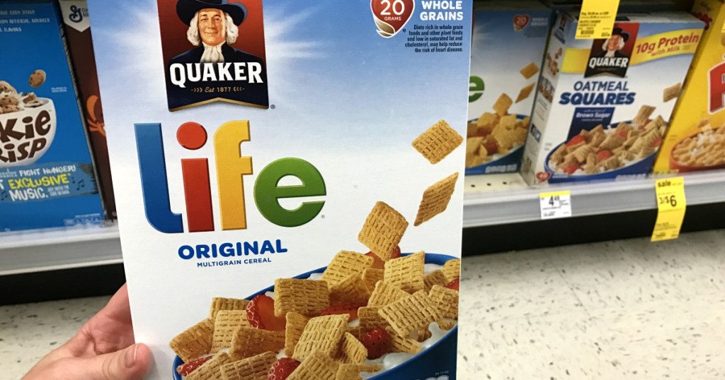 Hand holding Quaker Life Cereal