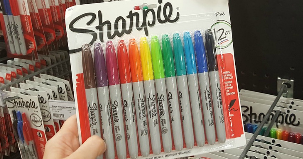 hand holding up Sharpie markers