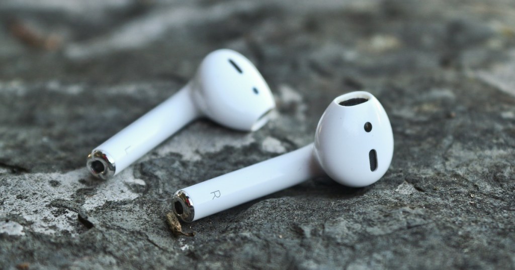 apple airpods laying on a marble tabletop
