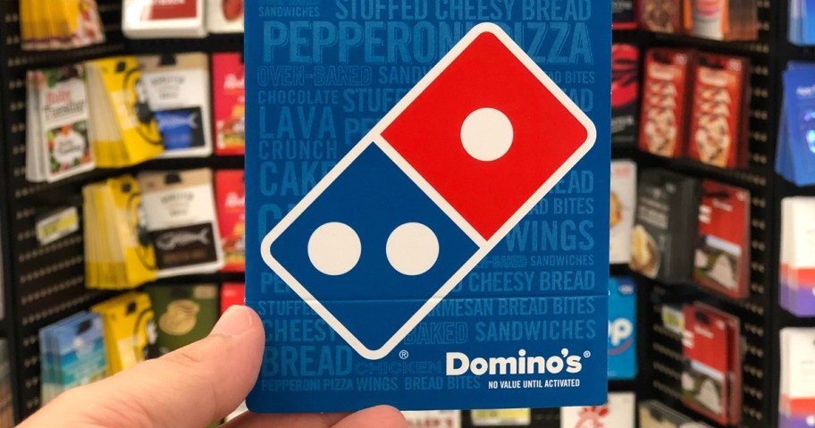hand holding a Domino's gift card