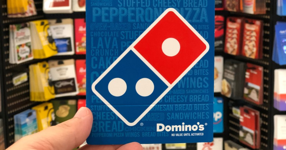holding a Domino's gift card