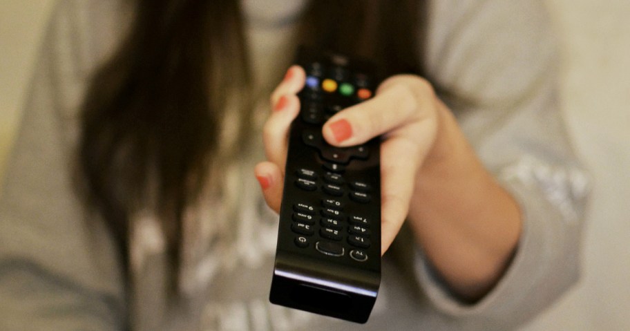 woman holding out a remote