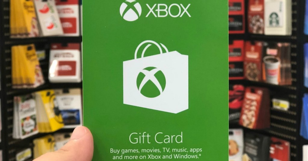 xbox gift card being held up in front of gift card in store display