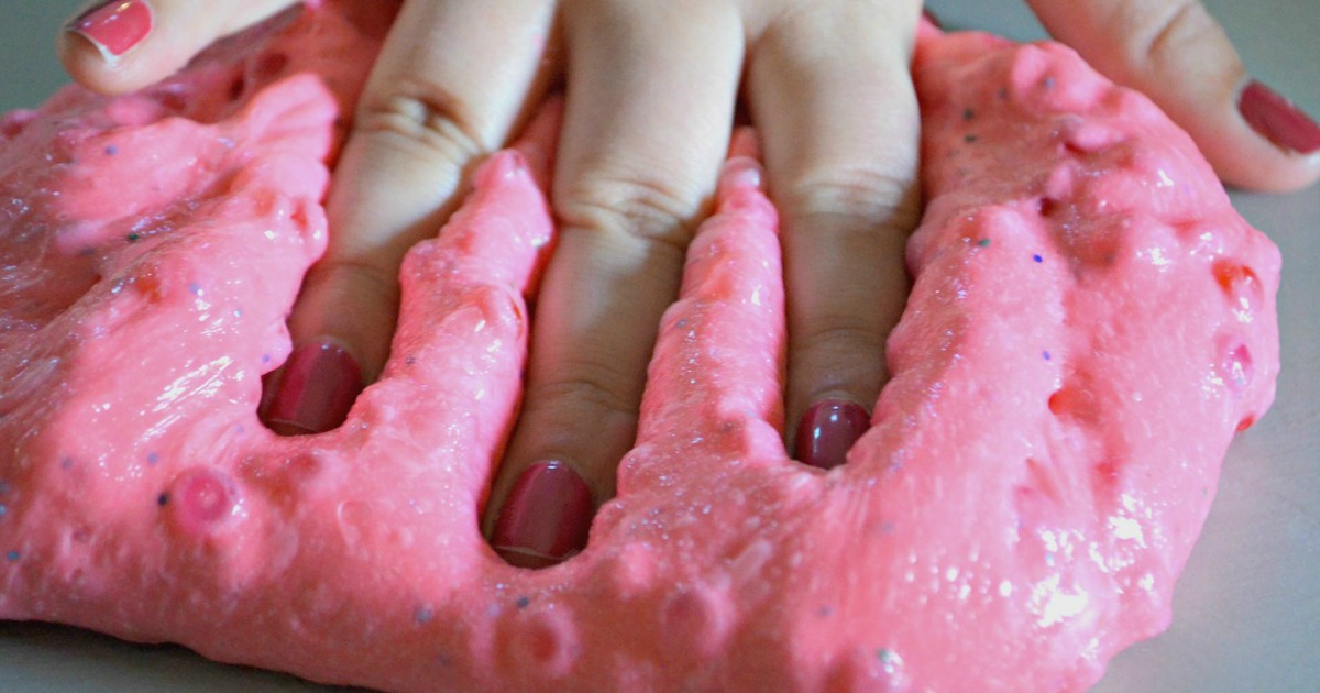 hand in pink crunchy slime 