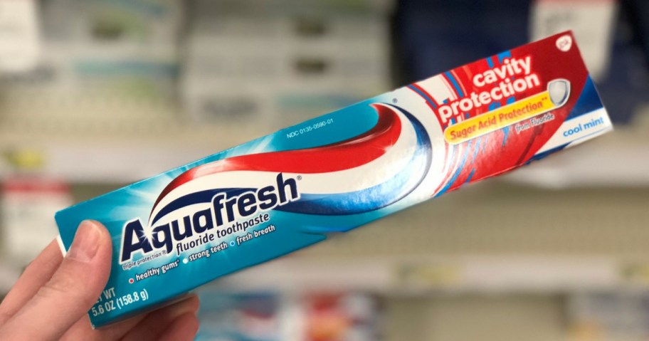 hand holding aquafresh cavity protection tube