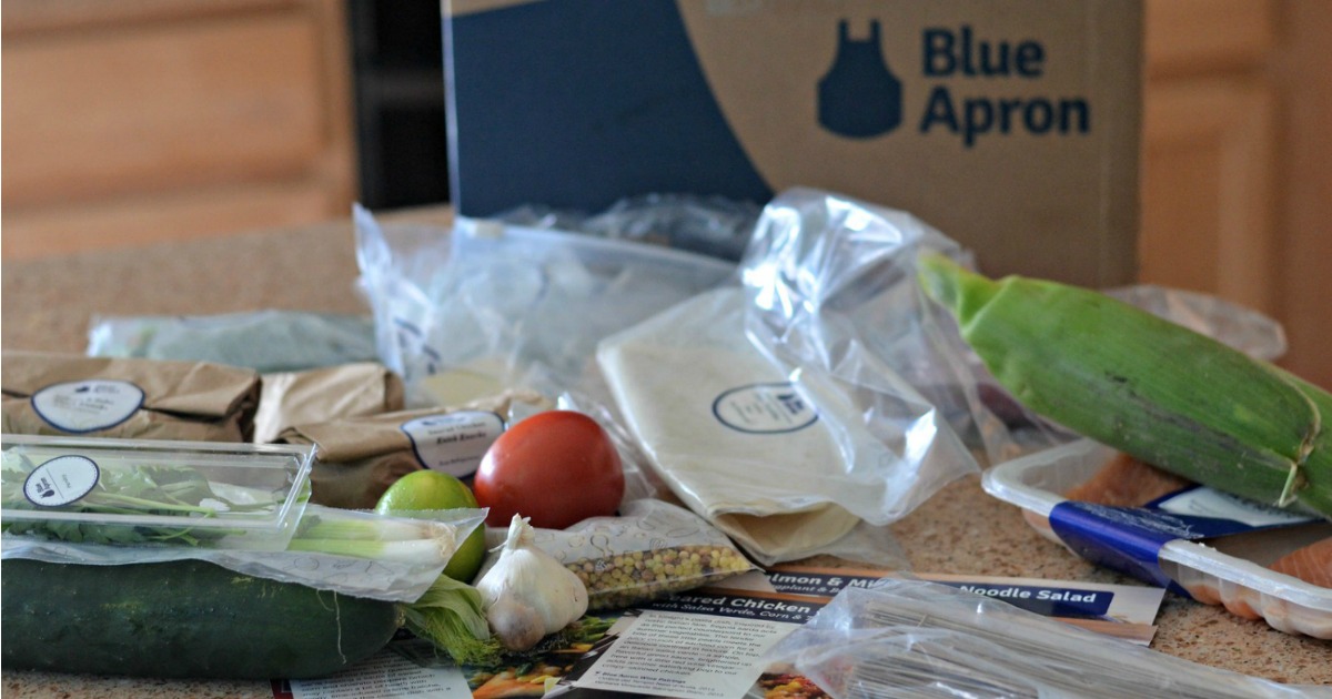 A Blue Apron box with ingredients on a counter
