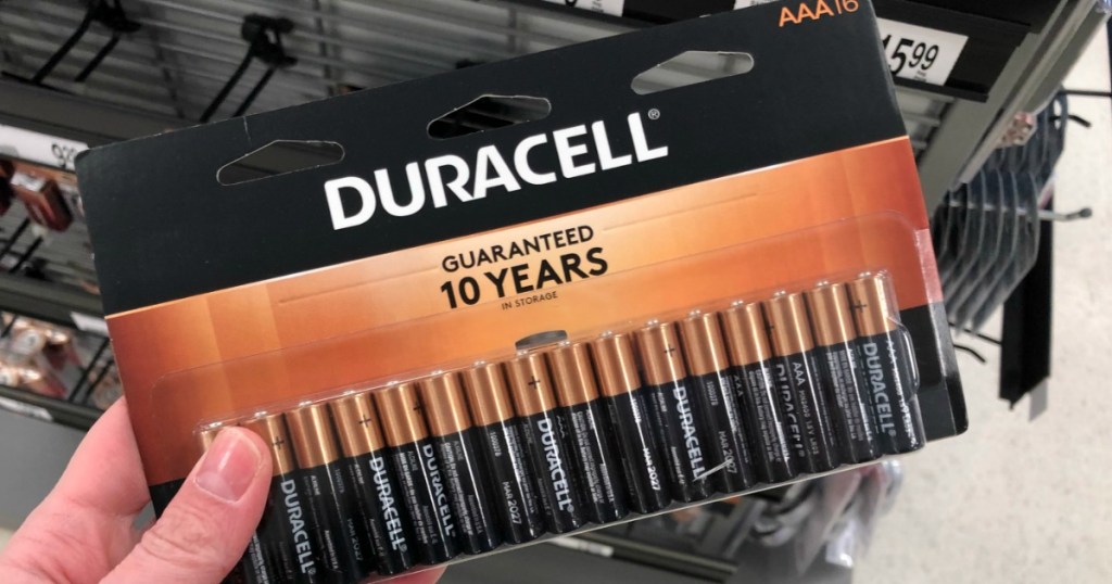 hand holding pack of Duracell batteries