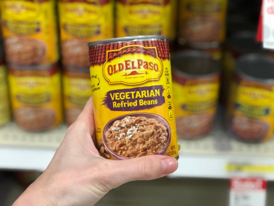 old el paso beans can being held up in store aisle