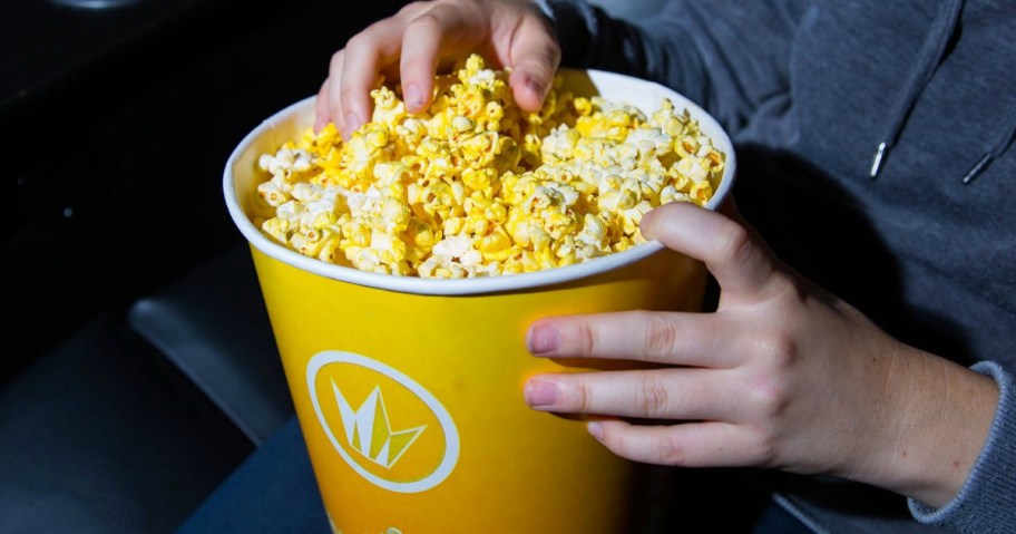 person eating popcorn at Regal Theatres