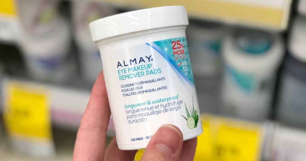 Hand holding up Almay Eye Makeup Remover Pads