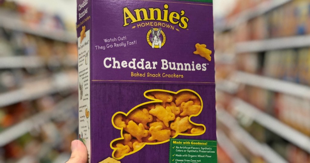 hand holding box of annies cheddar bunnies in store