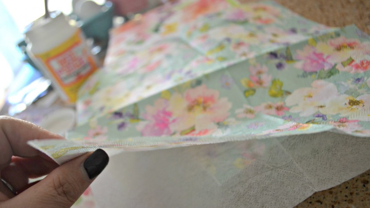 placing napkin strips onto diy decoupage easter eggs