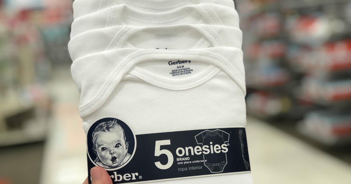 hand holding up a pack of gerber baby onesies in a store aisle