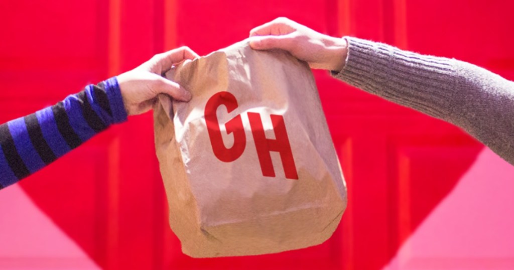 hands holding up GH paper bag
