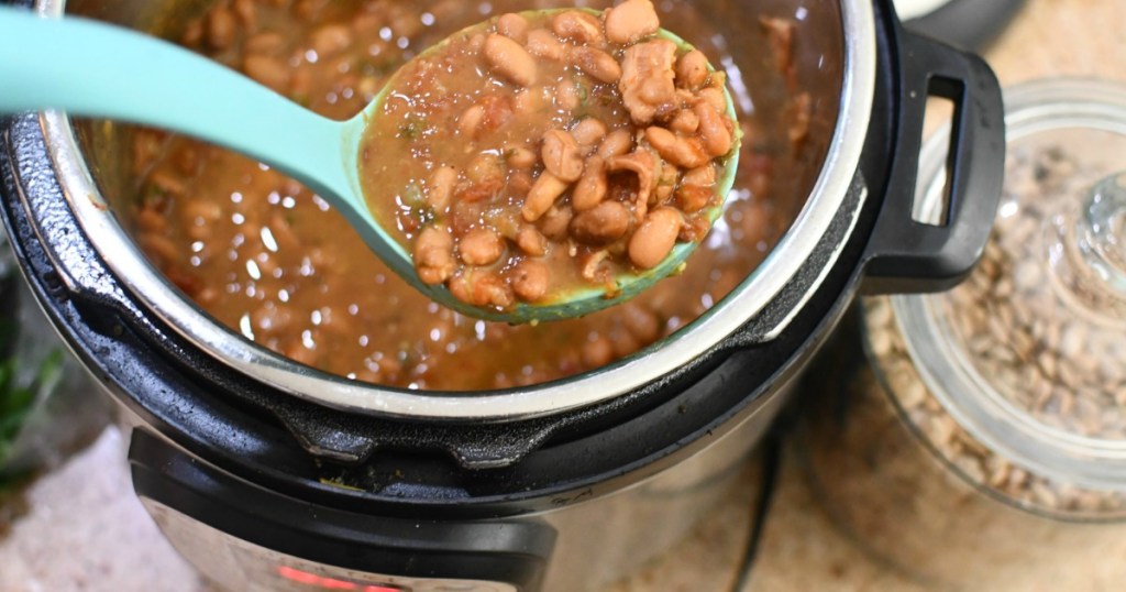 large spoon scooping out beans from Instant Pot 