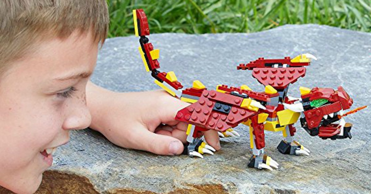boy playing with a LEGO dragon