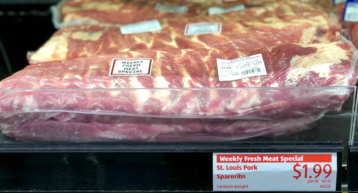 aldi spareribs in packaging on store shelf with weekly special price sign