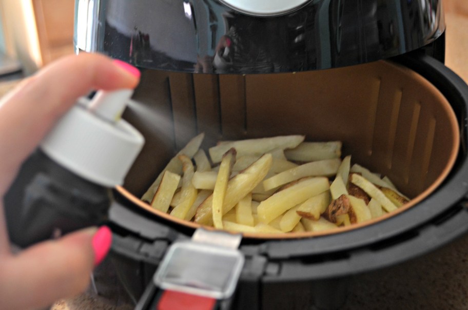 Adding cooking spray to air fryer, one of our best air fryer hacks