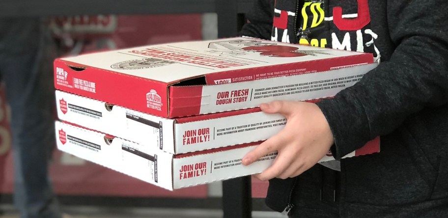 person holding 3 Papa John's boxes