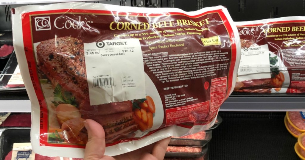 hand holding package of corned beef