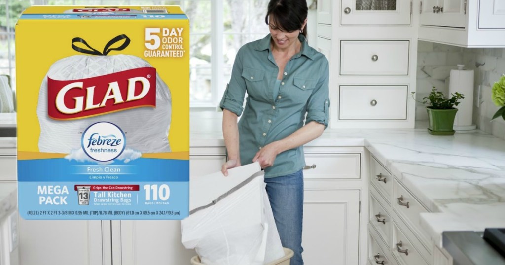 woman using glad trash bags with box in corner