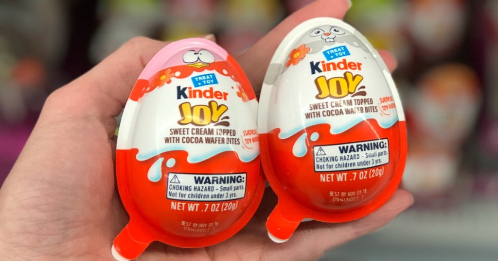kinder joy eggs in a hand