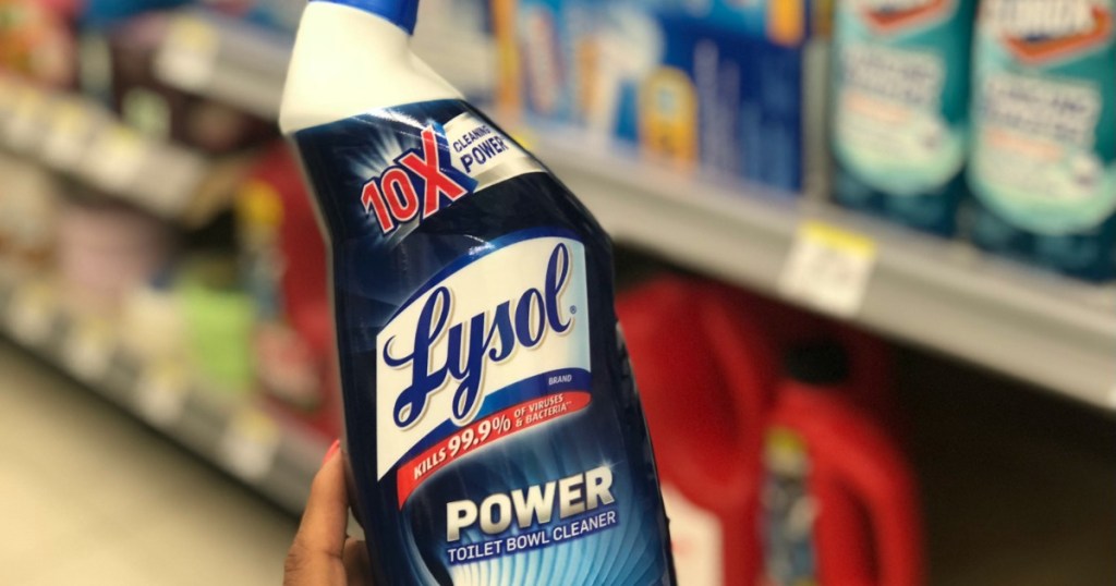 hand holding lysol toilet bowl cleaner with blurry background