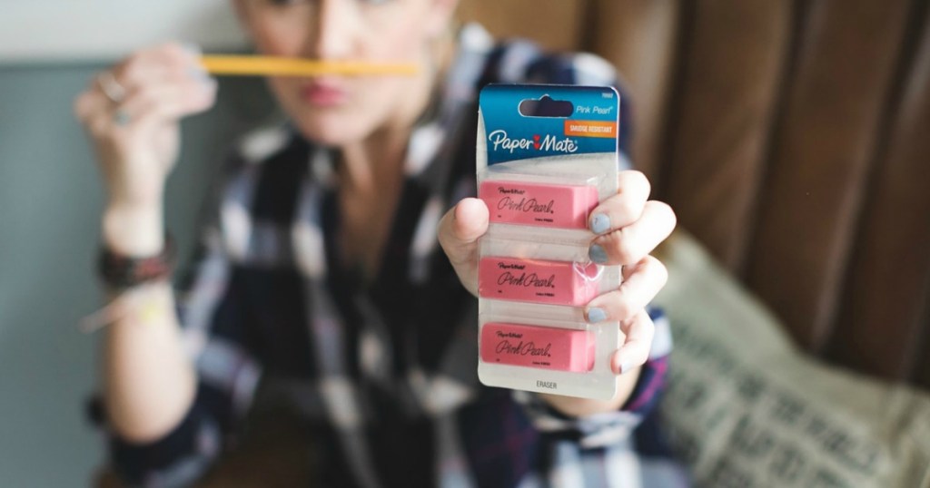 Woman holding a pack of erasers
