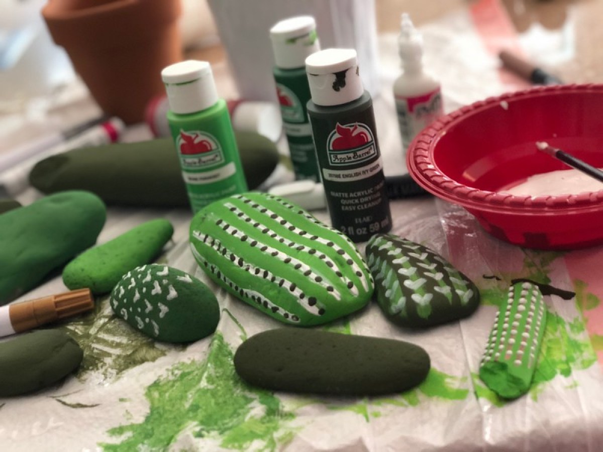 painting cactus rocks with green paint 