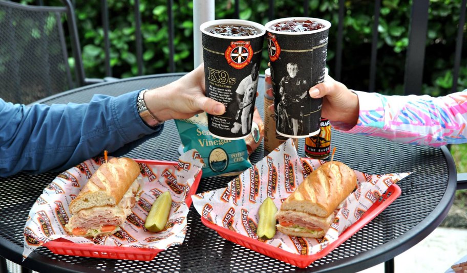 cheersing two soda cups over firehouse subs