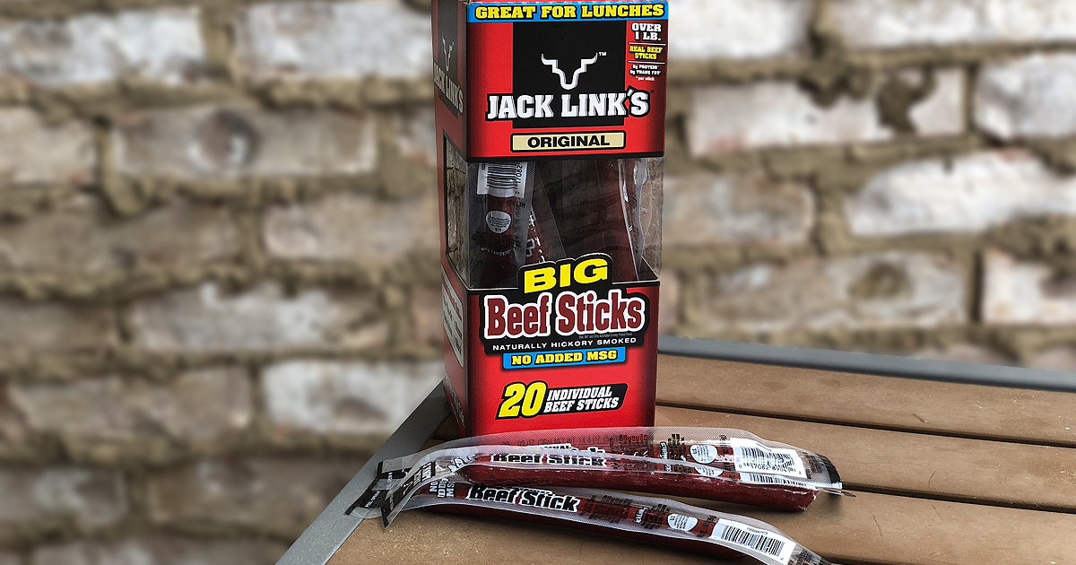 box of jack link's beef jerky sticks in box and on table in front of a brick wall