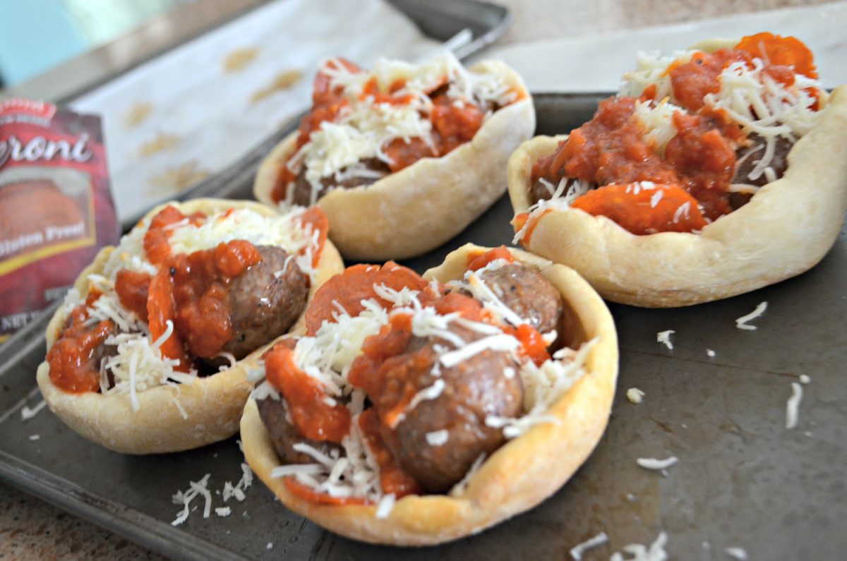 copycat Olive Garden meatball pizza bowls on a baking sheet, ready to go into the oven 
