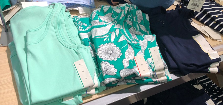 tank tops on table in store