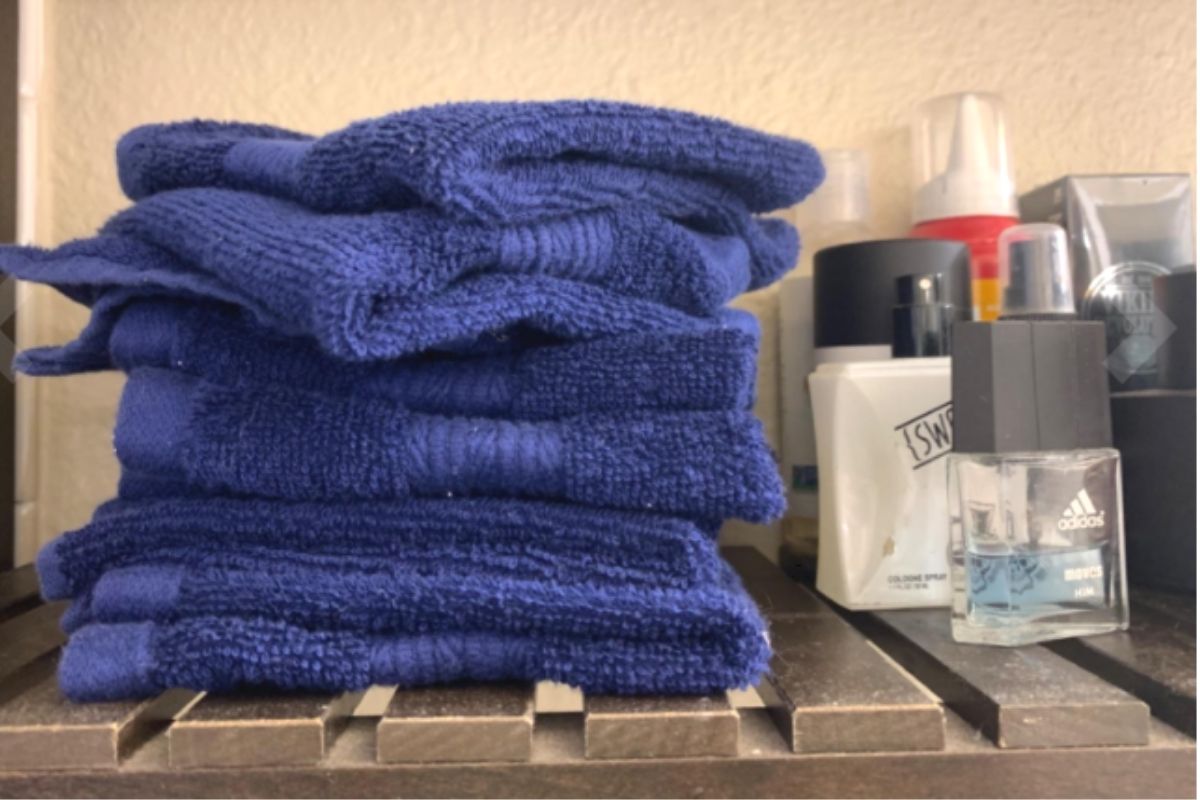 Folded bath towels on a shelf