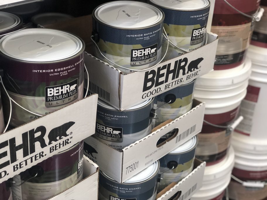 behr paint stacked on floor in store