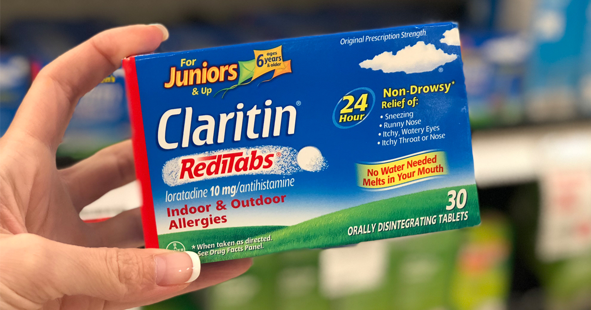 hand holding a box of claritin juniors allergy medicine in a store