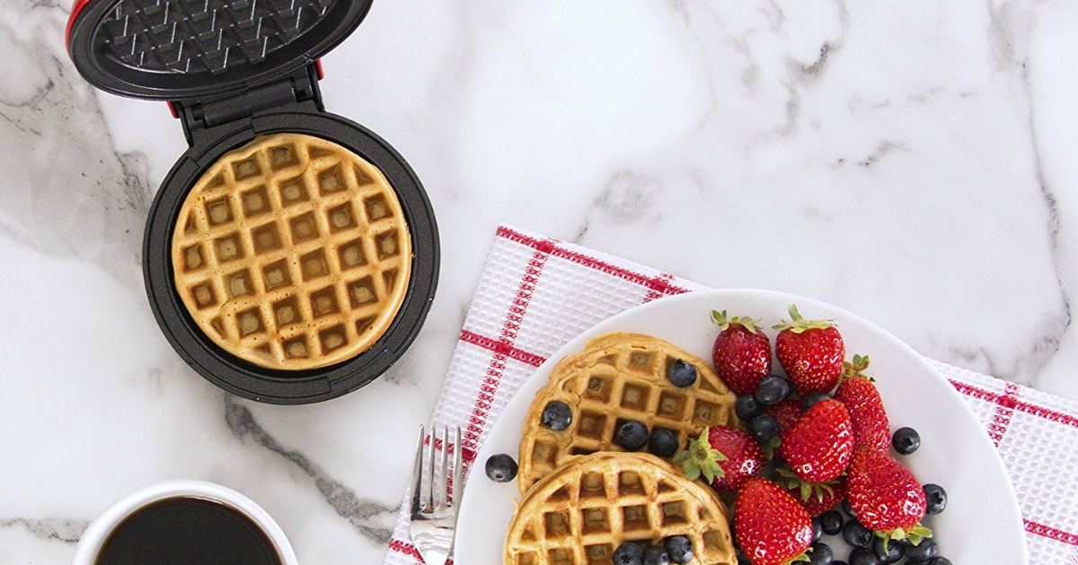 mini waffle maker next to a plate of waffles and fruit