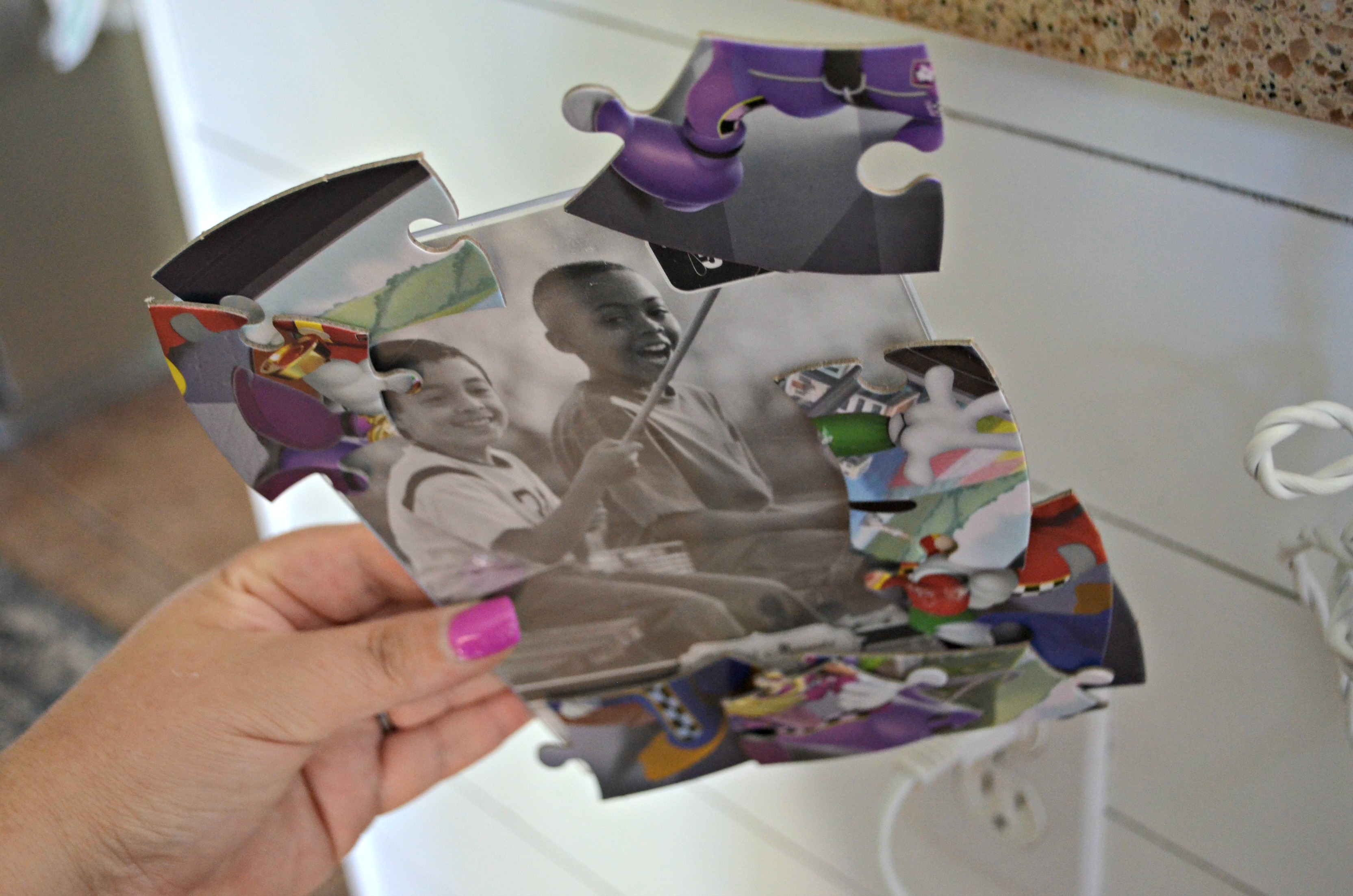 dollar tree Disney puzzle frame craft - gluing on the puzzle pieces
